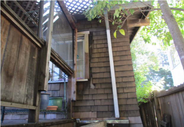 The missing siding and where does the gutter lead to?